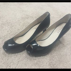 Guess brand patent leather black peep toe heels.